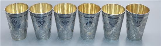 A set of six Persian engraved white metal beaker cups, 684 grams